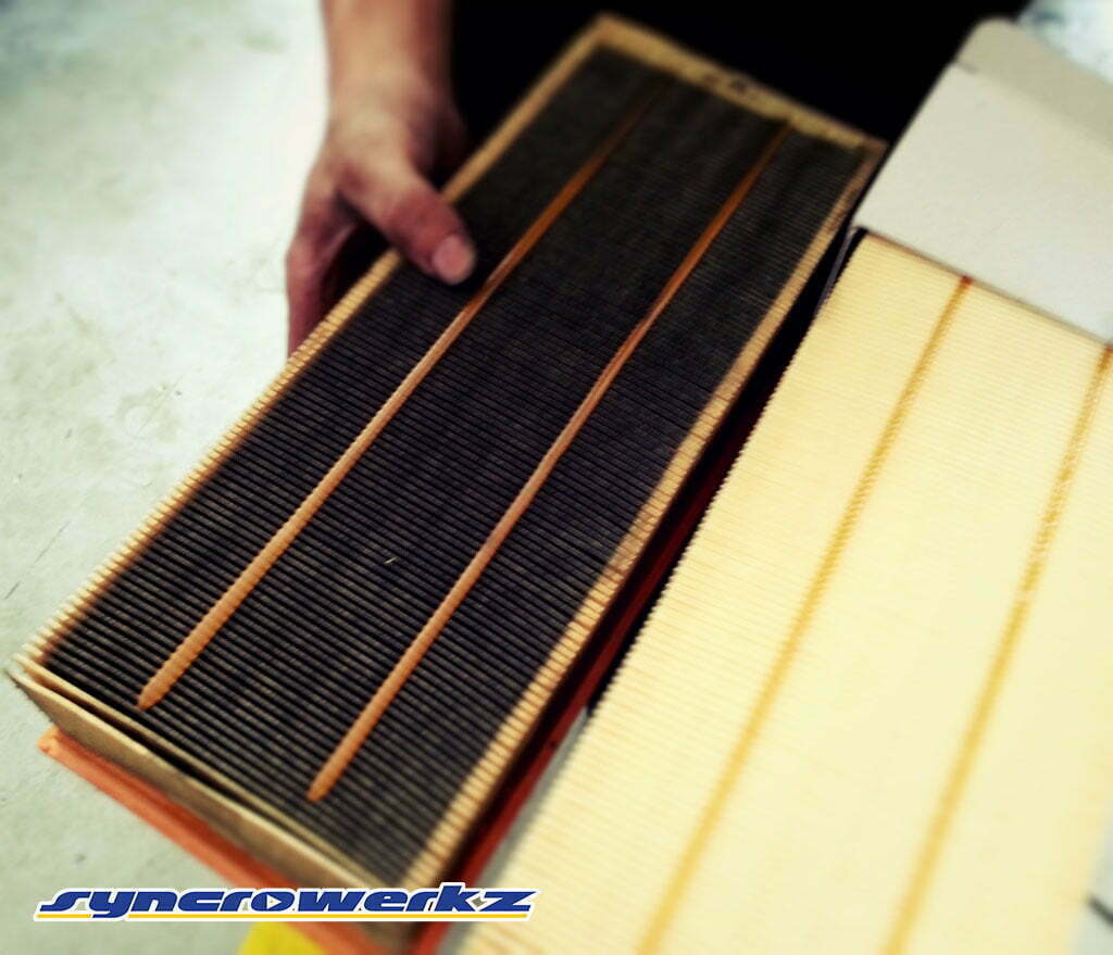 A clogged and dirty engine air filter shown next to a clean volkswagen engine air filter